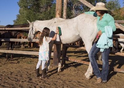 Girl Grooming Horse with Wrangler Lazy L&B Dude Ranch Wyoming